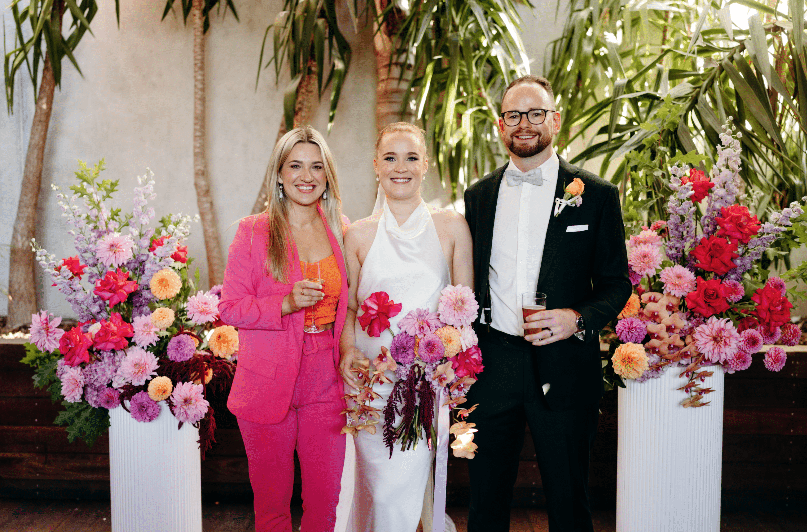 Colourful Brunswick Wedding Celebrant Aleks Mac Poses with Newlyweds at Post Office Hotel in Coburg